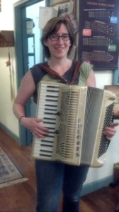 A happy accordionist with a repaired accordion